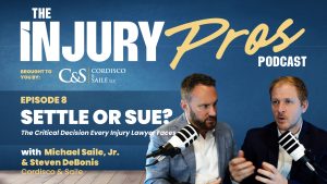 Two men in suits discuss on "The Injury Pros Podcast" episode titled "Settle or Sue?" with podcast branding and episode details displayed in the background.