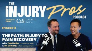 Two men sit in front of microphones on a podcast set with "The Injury Pros Podcast" and episode details displayed in the background.