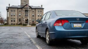 Honda sedan with Pennsylvania license plate parked outside historic courthouse building