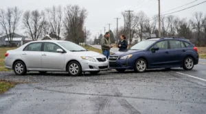 two drivers exchanging information beside vehicles involved in rural road collision